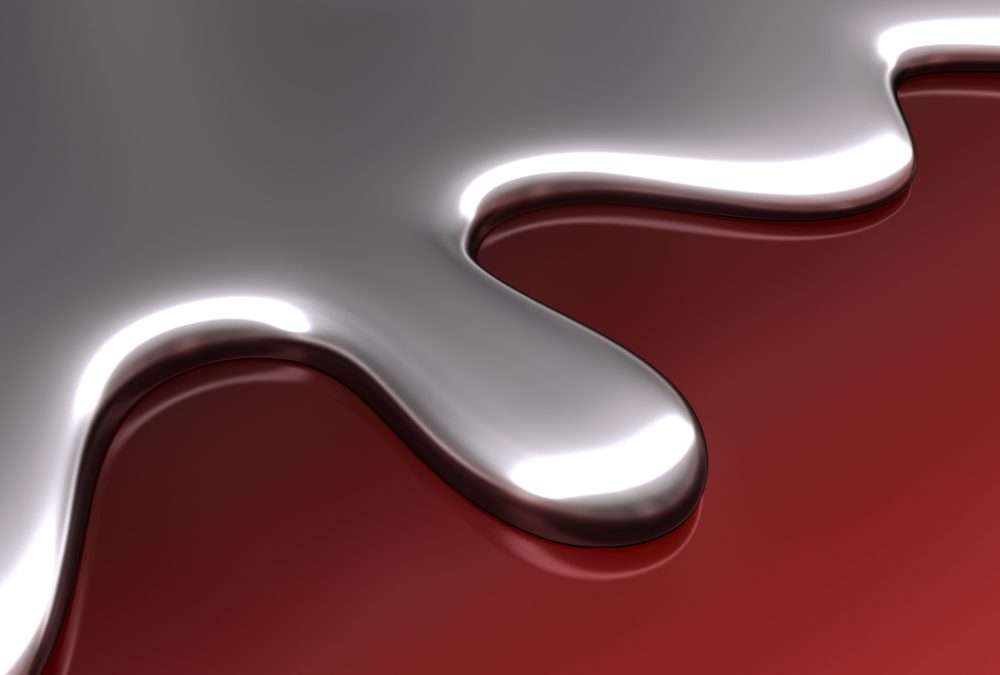 liquid mercury on red background