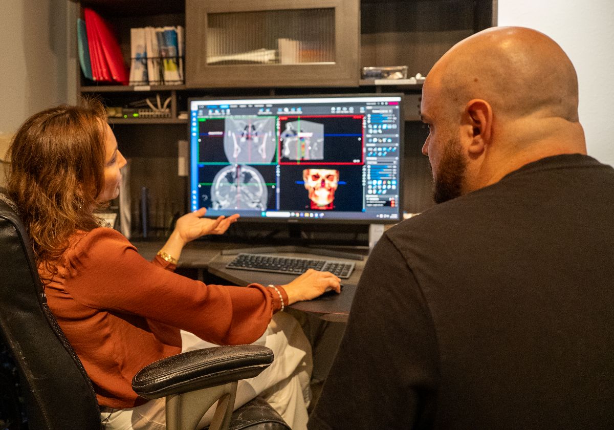 Dr. Candace Bruno reviewing dental scans with a patient